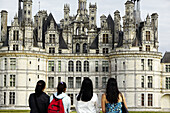Four women looking at the Chateau of Chambord. Loire Valley. France
