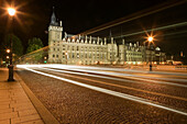 Moving traffic lights passing by the Conciergerie on Pont au Change at night. Paris. France