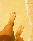 Woman with blue toenails on beach