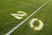 Painted yardage lines of football field, some being painted