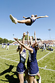 Cheerleaders performing during football game
