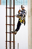 Construction worker with protective clothing and hard hats work on building. Sarasota. Florida, USA