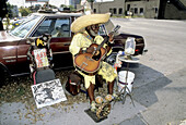 Nashville Tennessee TN street musician Boots Roots plays guitar and sings for donations