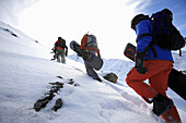 Snowboarders ascending, See, ski region Paznaun, Tyrol, Austria
