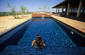 woman in the pool at the homestead of Wrotham Park Lodge, Cape York Peninsula, Queensland, Australia