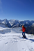Female backcountry skier ascending, Pyramidenspitze, Eggersgrinn, Zahmer Kaiser, Kaiser range, Tyrol, Austria