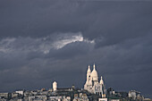 The basilica Sacre Coeur under clouded sky, Montmartre, Paris, France, Europe