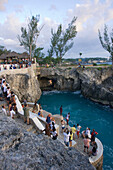Jamaica Negril Ricks Cafe Cliff Diver jumping from a Tree,  crowd