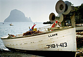 Fishing boat at Cala dHort and Es Vedrà small island in background. Ibiza, Balearic Islands. Spain