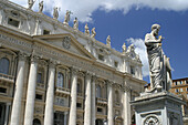 Statue of Saint Peter, and St. Peters Basilica facade. Vatican City. Rome. Italy