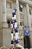 Castellers (catalan tradition), human tower during the Mercè Festival in front of the city hall. Plaça de Sant Jaume. Barcelona. Spain.