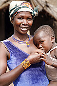 Portrait of young Gan woman breastfeeding children, Loropeni. Burkina Faso