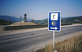 Monument to pilgrims and sign. Road to Santiago, Spain