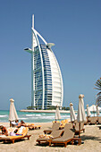 Tourists at beach. Burj Al Arab hotel. Dubai. UAE (United Arab Emirates)