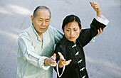 tai chi instructor teaching female student