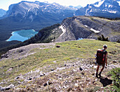 Hiker on Sunset Pass with Pinto lake in the background. Banff National Park. Alberta. Canada
