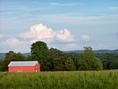 Barn in field sits under a summer sky in Hunterdon County. New Jersey, USA