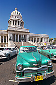 Classic American cars from the 1950s parked in front of the Capitolio Nacional. Havana, Cuba