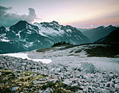 Setting sun over Nooksack Ridge from Hannegan Peak. Mount Baker. Washington. USA.