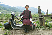 School boy, Haa, Bhutan, sitting on a scooter