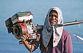 Fisherman with his boat engine. Bali, Indonesia