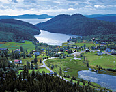 Village, coastline, seashore, houses, water, mountains, way, road. Häggvik. Ångermanland. Sweden.