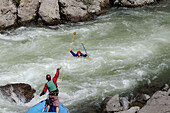 A rafter rescues a man from the rapids while rafting on the Truckee River in California. USA