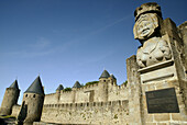 Statue of Madame Carcas welcomes to La Cité, Carcassonne medieval fortified town. Aude, Languedoc-Roussillon, France