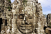 Stone face, detail of Temple of Bayon, complex of Angkor Thom. Angkor. Cambodia