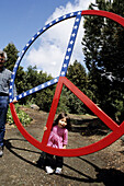 Child with giant peace sign, Berkeley. California, USA
