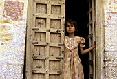 Girl in doorway, Jodhpur. Rajasthan, India