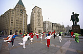 Early morning exercisers in Huangpu Park, The Bund in background. Shanghai, China