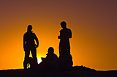 Silhouette of people watching sunset at Moon Valley (Valle de la Luna), Salt Mountain Range, Atacama Desert, Chile