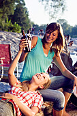 Two young women drinking beer, Munich, Bavaria, Germany