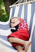 Girl (3-4 years) sleeping in a hammock