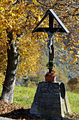 A cross with the autumn light in the mountains near La Salle in valle dAosta, Italy
