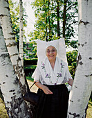Marga Morgenstern, 72 years old, the Alte Spreewald`sche, Wend from Lübben, wendish traditional costume, birch trees, Lübben, Lower Spreewald, biosphere reservat, Spreewald, Brandenburg, Germany