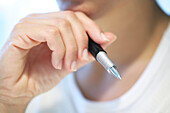 Close up of a hand holding a pen, Thinking, Business