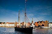 Sailer on river Trave, Lubeck in background, Schleswig-Holstein, Germany