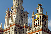 Stalin-era building of Moscow state university with clock and statues, Moscow, Russia