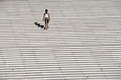 Woman on stairs. La Defense, Paris. France