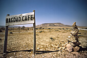 A sign marks the location of the Bagdad Café on the road junction to Iraq, AlUlayyaniyah in the Syrian desert. Syria