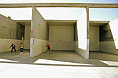 Man playing ball by himself in one court and couple of friends playing in next court, Venice Beach, California United, States