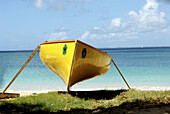 Beached canoe, sea in background