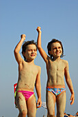 Happy 6 year old girls on Bolonia beach, Tarifa. Cadiz province, Andalusia, Spain
