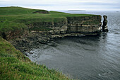 Cliffs at Duncansby Head with Orkney Islands in background. Scotland, UK