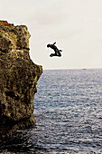 Man diving from cliff. Negril. Jamaica.