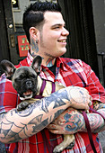 Tatooed man with dog, East Village. NYC. USA.