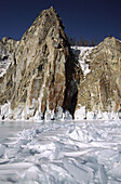 Granite cliffs and frozen Baikal lake, Siberia, Russia