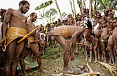 Yalis men making fire in traditional wearing with penis cases and ratan girdles, Western Papuasia, Former Irian-Jaya, Indonesia